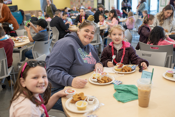 Read Across America 2025. Students and families enjoying breakfast.